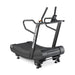 The Bells of Steel Blitz Magnetic Resistance Manual Treadmill is a black, curved treadmill with sturdy handrails, a digital display, and a slatted surface for sled push workouts, shown against a white background.
