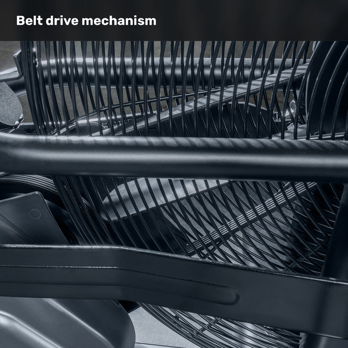 Close-up view of the Blitz Air Bike's belt drive mechanism by Bells of Steel, showing interwoven black metal bars and components. Text at the top reads "Belt drive mechanism.